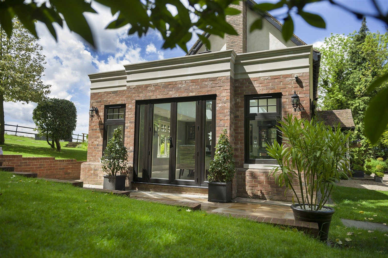 Slim dark aluminium grid doors showing a steel-look architectural route