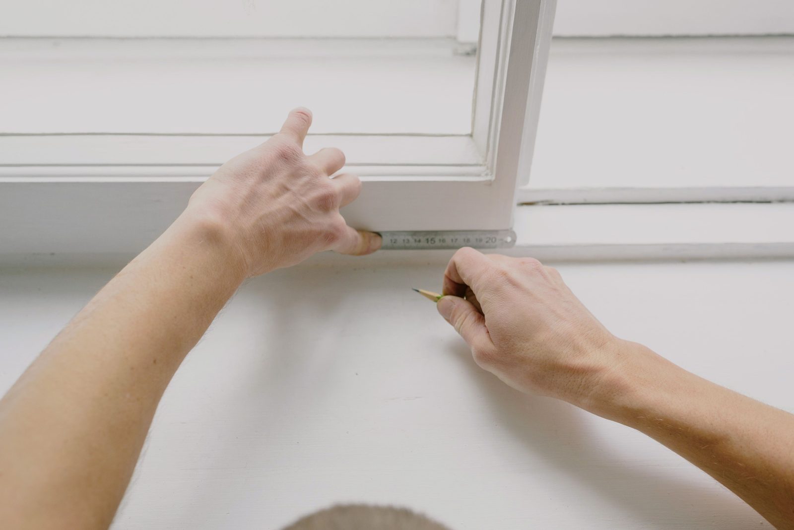 Surveyor measuring a window frame