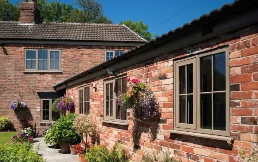 Brick house with black aluminium windows and a front garden